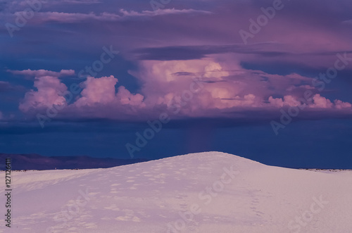 A beautiful purple sunset with cloudy stormy sky at White Sand Dunes National Monument.