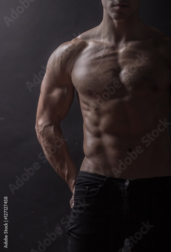 man bodybulider close up, abs core chest arms biceps.