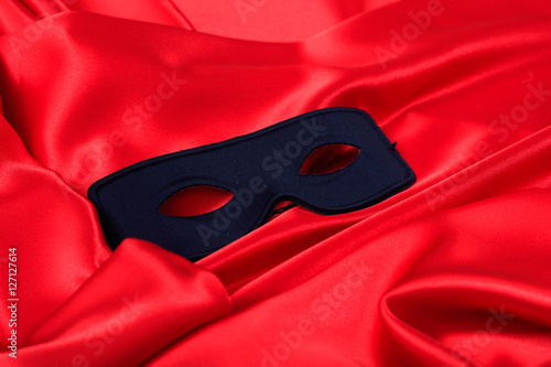 Carnival mask isolated on red satin background