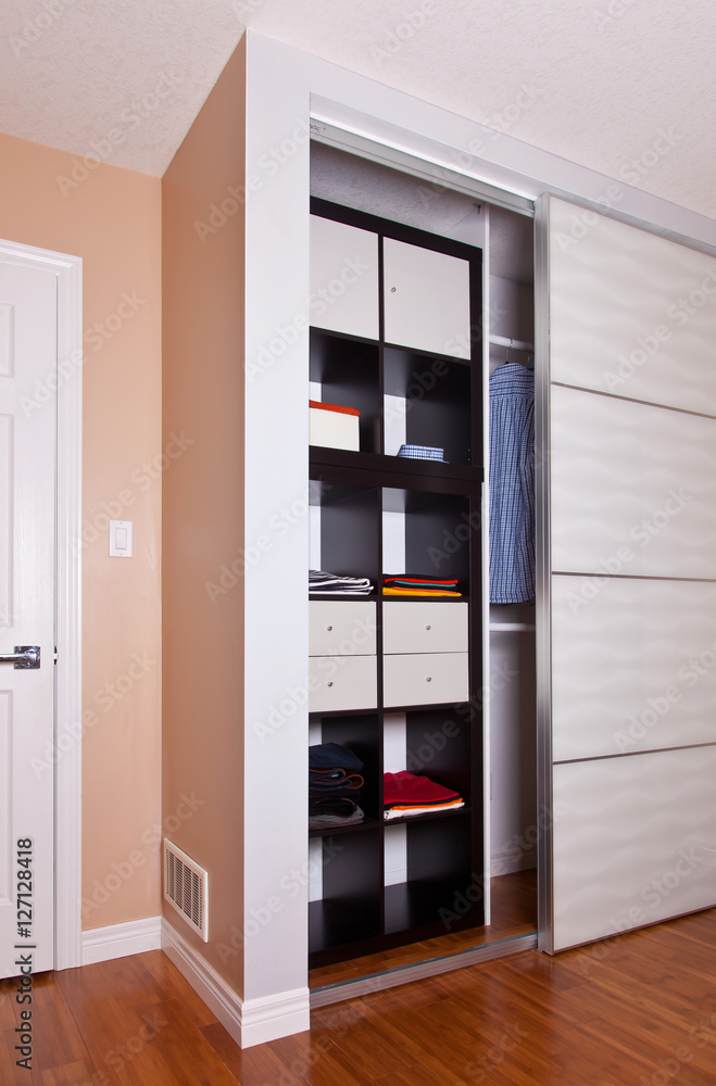 Built-in closet with sliding door shelving storage organization Built-in closet with sliding door shelving storage organization