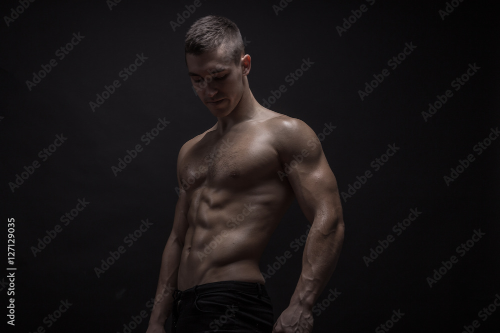 young man posing, bodybuilder strong muscular