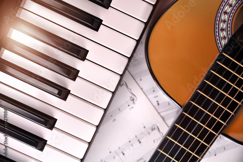 Piano and guitar with shine and sheet music background top