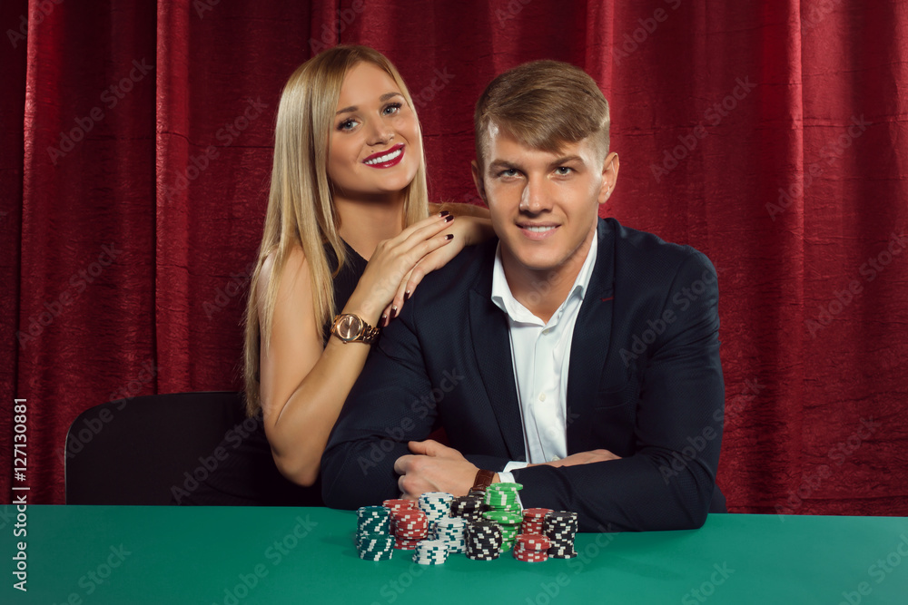 Young couple playing poker at the casino Young couple playing poker at the casino
