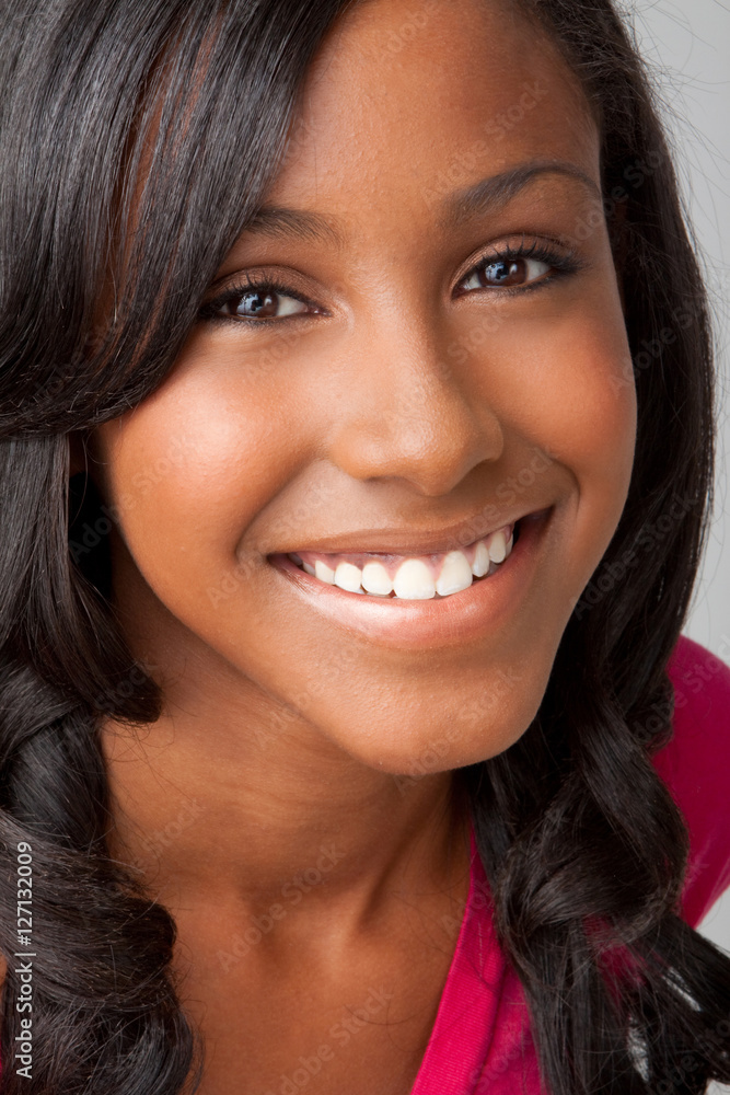 Beautiful smiling face of a happy African teenager girl, isolated.
Beautiful smiling face of a happy African teenager girl, isolated.