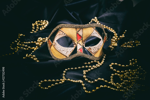 Carnival mask on black satin background