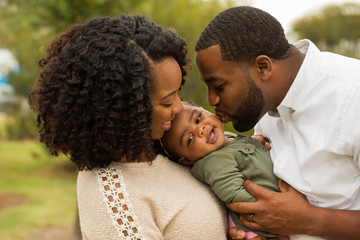 Happy family. Mother father and baby girl. 