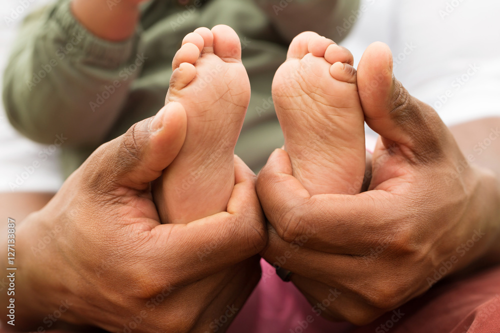 Father holding his daughters little feet. Father holding his daughters little feet.