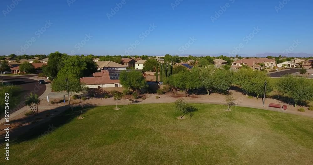 A daytime rising aerial establishing shot of a typical Arizona residential neighborhood. A daytime rising aerial establishing shot of a typical Arizona residential neighborhood.