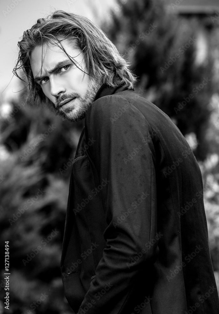 Black-white outdoor portrait of elegant long hair handsome man. Photos |  Adobe Stock
