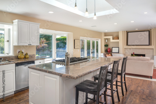 White Kitchen interior with kitchen island, granite counter tops