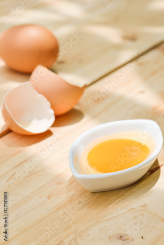 Raw egg on wooden table