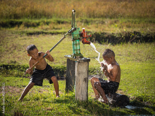 Two young boy rocking groundwater bathe in the hot days, Country