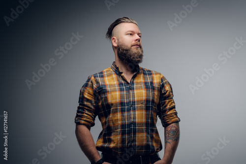 Portrait of a bearded male with punk hairstyle.