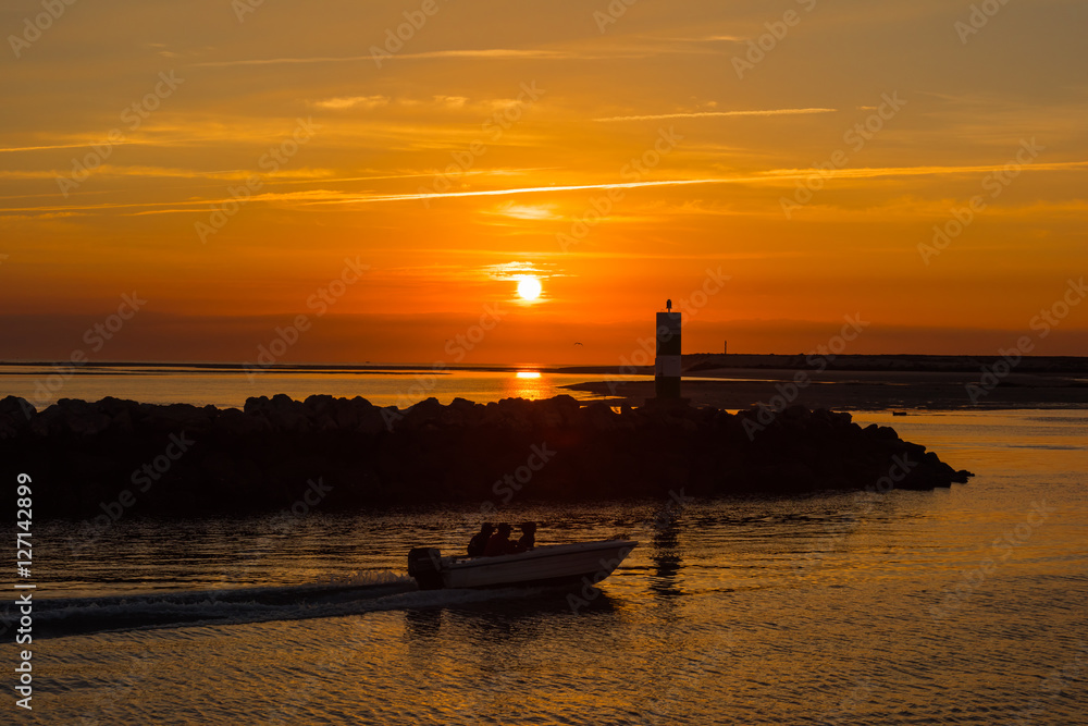 Portugal,Faro の漁港を日の出と共に出ていく漁師の船 / Portugal の最南端地方の町Faroに続く漁港を夜明けと共に出港する漁師の舟です。