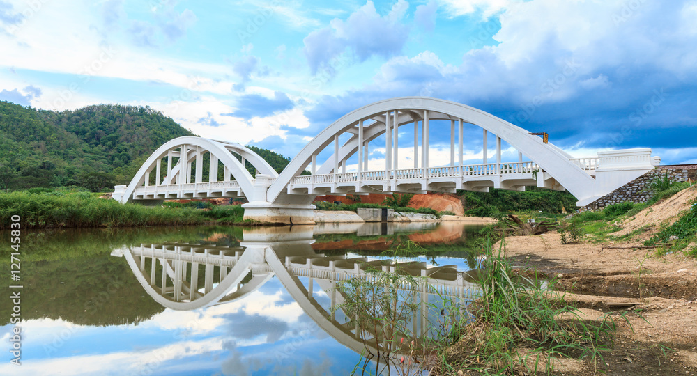 Fototapeta premium White bridge backdrop blue sky at mae tha, Lamphun, Thailand.