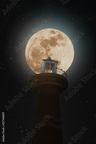 Full moon at night with lighthouse on clear sky with stars