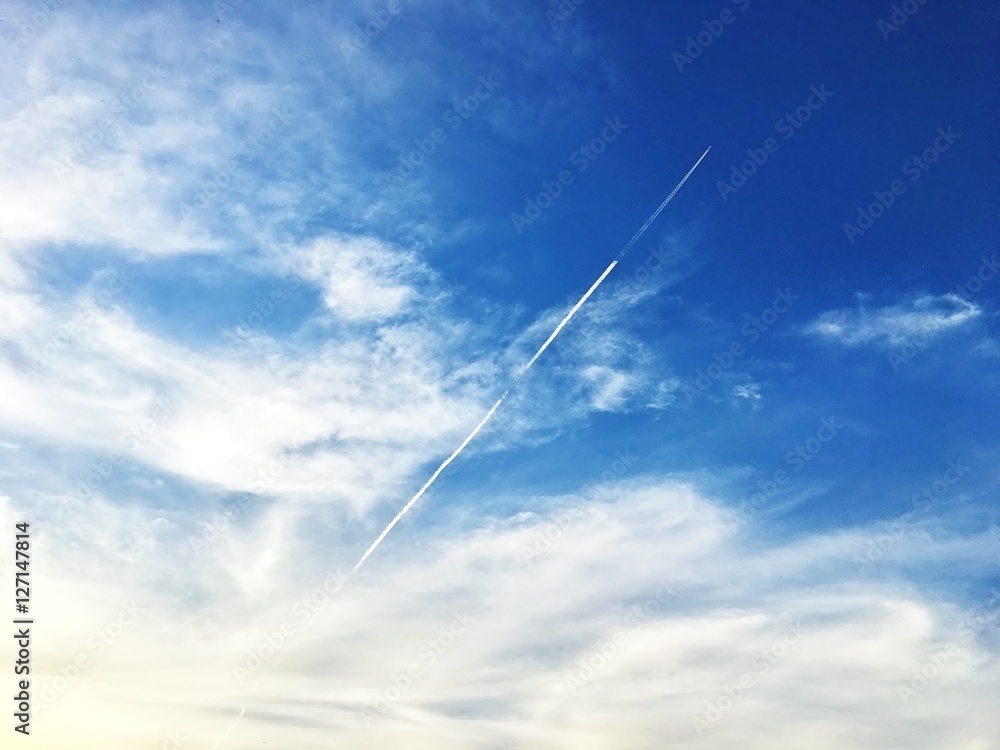 Aircraft contrails on a background and blue sky Aircraft contrails on a background and blue sky