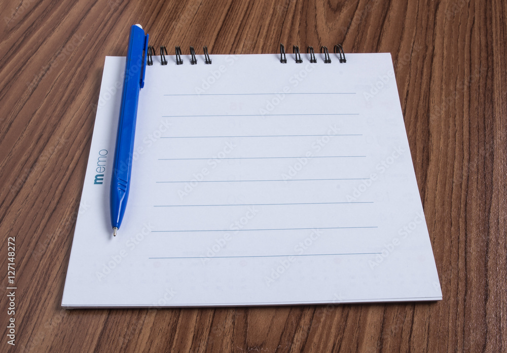 Blank notepad and ballpen on wood table. Blank notepad and ballpen on wood table.