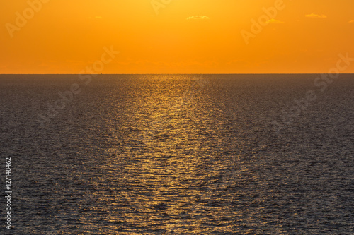 Golden stripe over the sea on a clear sunset