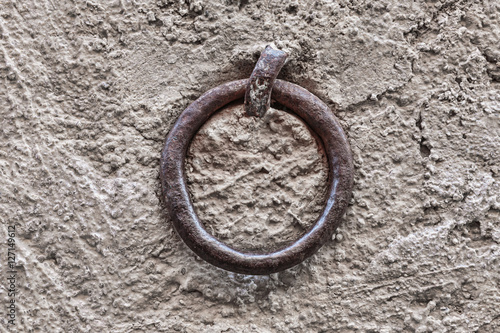 Old rusty ring on the stone wall