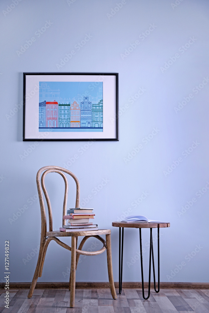 Simple interior with stool and decorations on blue wall background Simple interior with stool and decorations on blue wall background