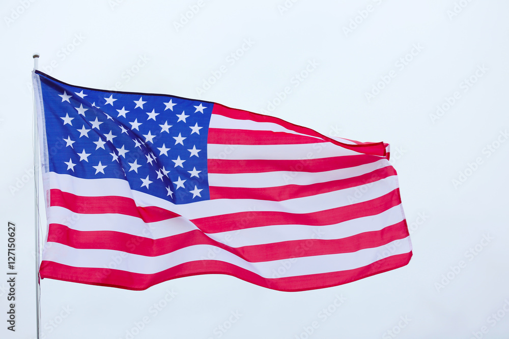 Fototapeta premium United States national flag on grey sky background