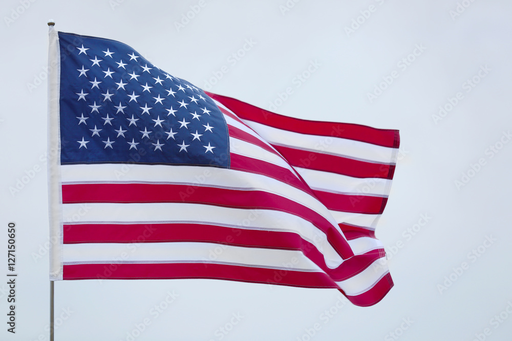 United States national flag on grey sky background