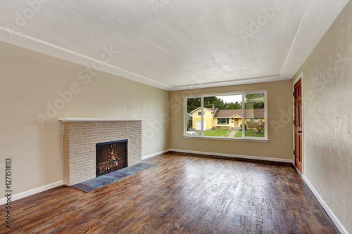 Unfurnished beige living room in empty house