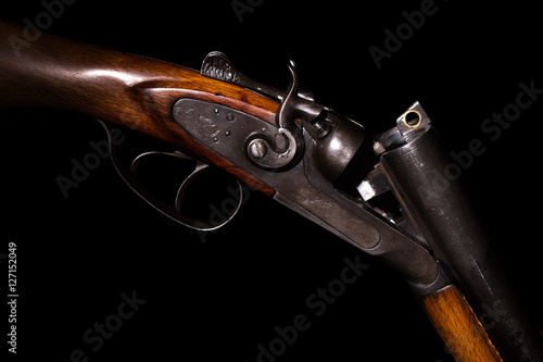 Double-barreled shotgun on a black background