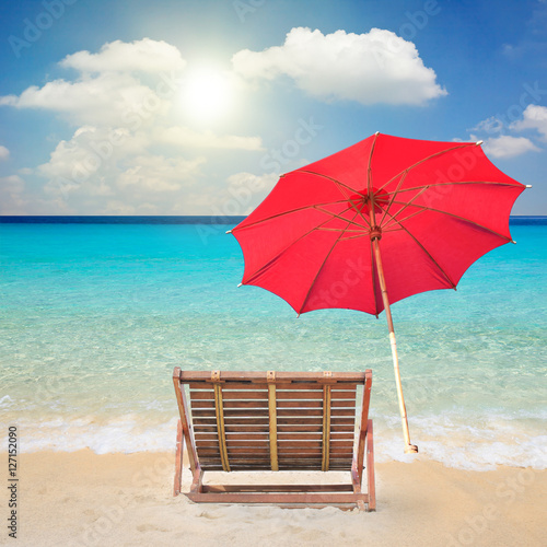 Fototapeta Naklejka Na Ścianę i Meble -  Wood chairs and red umbrella on the beach.