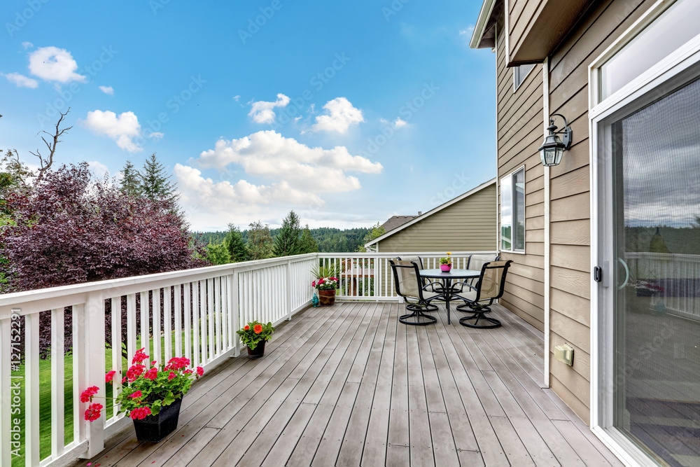 Wooden walkout deck with beautiful landscape view.