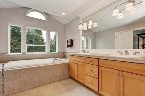 Spacious bathroom interior with double sink vanity cabinet.
