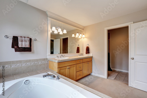 Bright and clean bathroom interior with double sink vanity cabinet.
