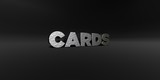 CARDS - hammered metal finish text on black studio - 3D rendered royalty free stock photo. This image can be used for an online website banner ad or a print postcard.