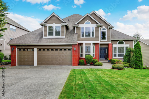 Beautiful curb appeal of beige house with red brick trim