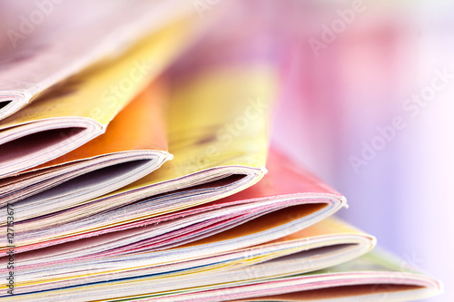 Close up edge of colorful magazine stacking 