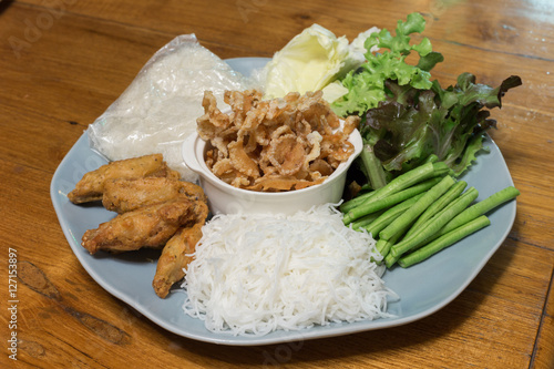 Thailand food set with fried chicken,pork snack,sticky rice,rice vermicelli,chilli sauce and vegetable