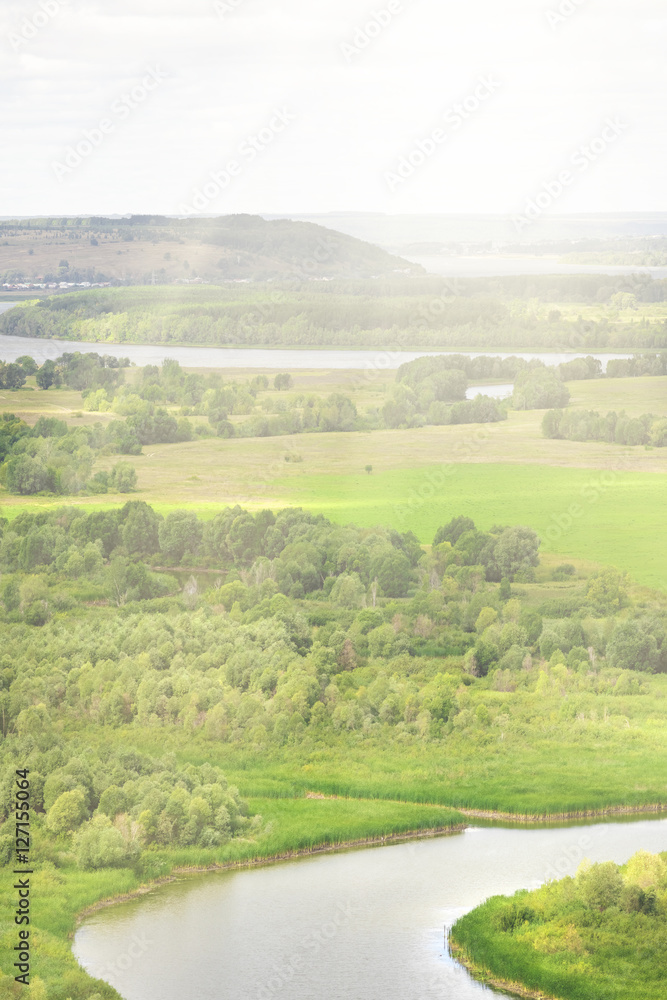 Fototapeta premium Green river valley in the sunlight