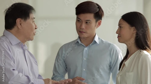 MS Senior businessman directing two colleagues / Singapore