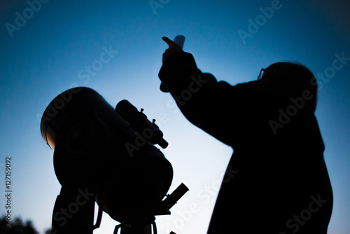 Fototapeta Naklejka Na Ścianę i Meble -  Astronomer and his astronomical telescope at night in front of the sky