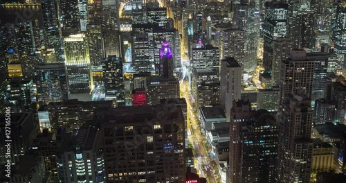 Chicago, Illinois, USA - view from the observatory of the John Hancock Center at illuminated City along Michigan Avenue at night with Tribune and Trump Tower - Timelapse without motion 