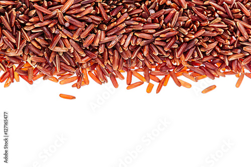 Border of red rice close-up  on white background. Isolated. Decorative frame of wild brown unpolished rice.