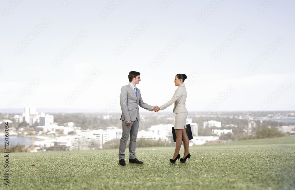 Business partners greeting each other . Mixed media Business partners greeting each other . Mixed media