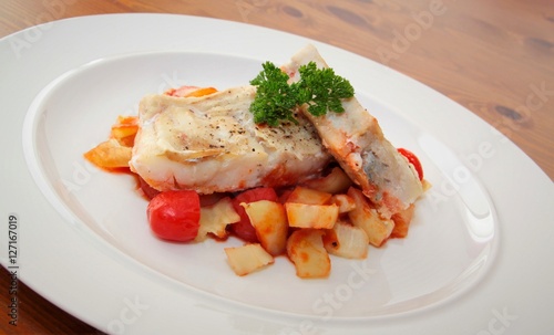 Fillet of codfish baked in tomato sauce and vegetable.