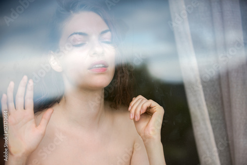 Nude beautiful woman at the window