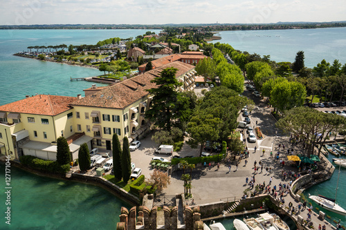 View of colorful old buildings in Sirmione and Lake Garda from Scaliger castle wall, Italy photo