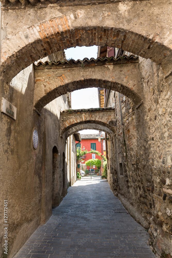 Picturesque narrow town street  in Sirmione, Lake Garda Italy.