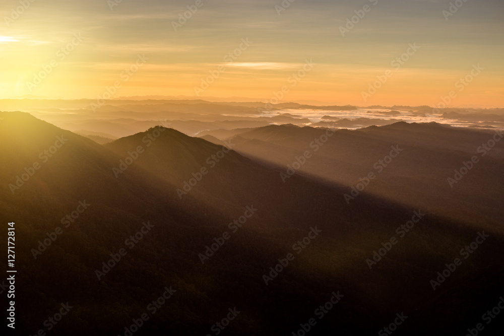 beautiful sun rise on top mountain with sun ray warm tone
