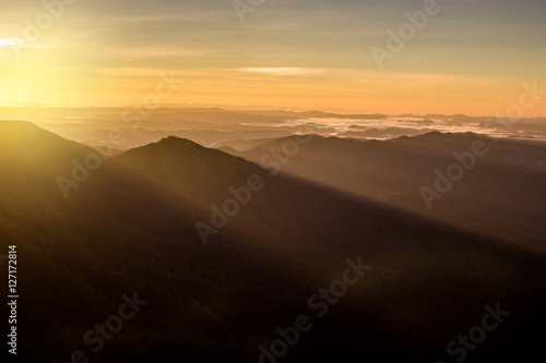 beautiful sun rise on top mountain with sun ray warm tone © golfnmd50