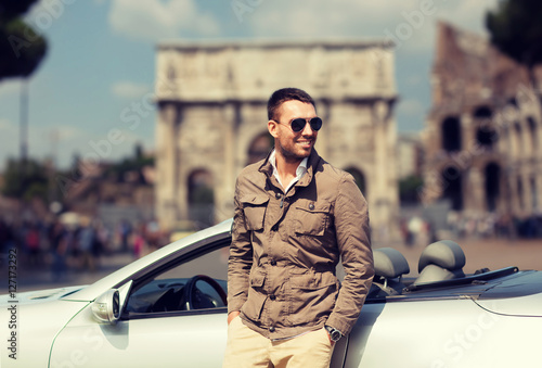 Photography happy man driving cabriolet car over city of rome